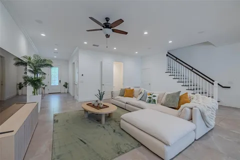 a living room with furniture and wooden floor