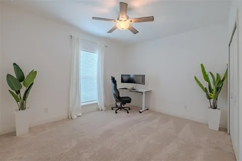 a view of a workspace with furniture and a potted plant