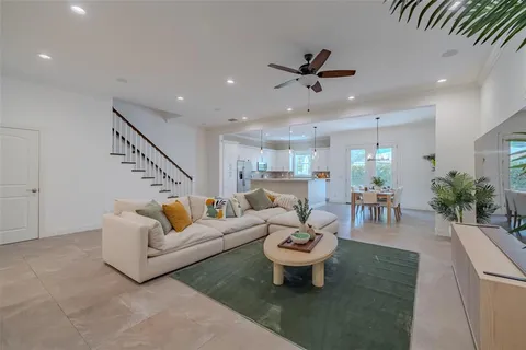 a living room with furniture a rug and a chandelier