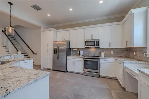 a kitchen with a sink stainless steel appliances and cabinets