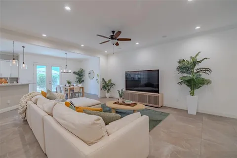 a living room with furniture potted plant and a flat screen tv