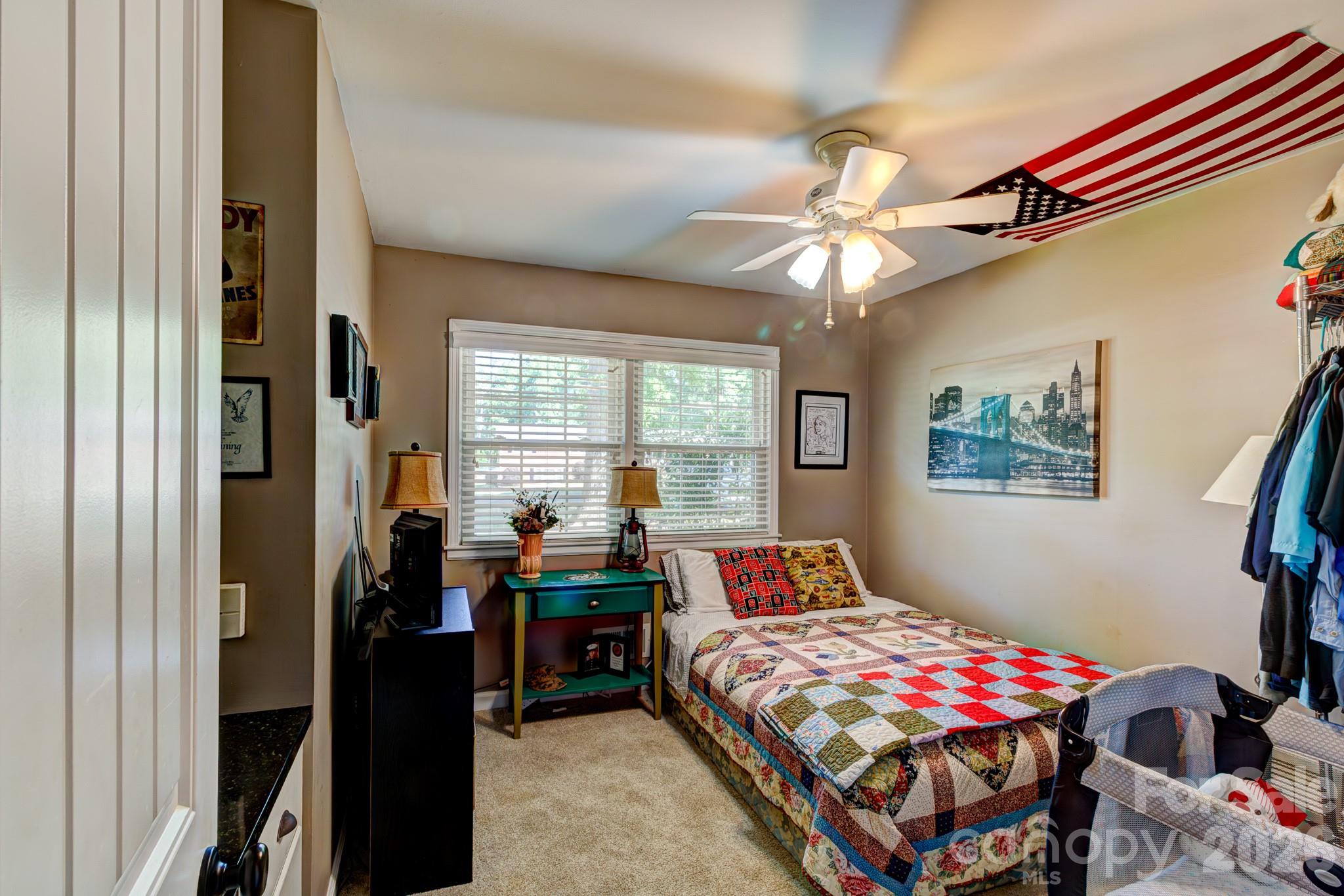 113 Delview Drive Cherryville, NC 28021 - Photo 12 of 26 a bedroom with a bed and a chandelier