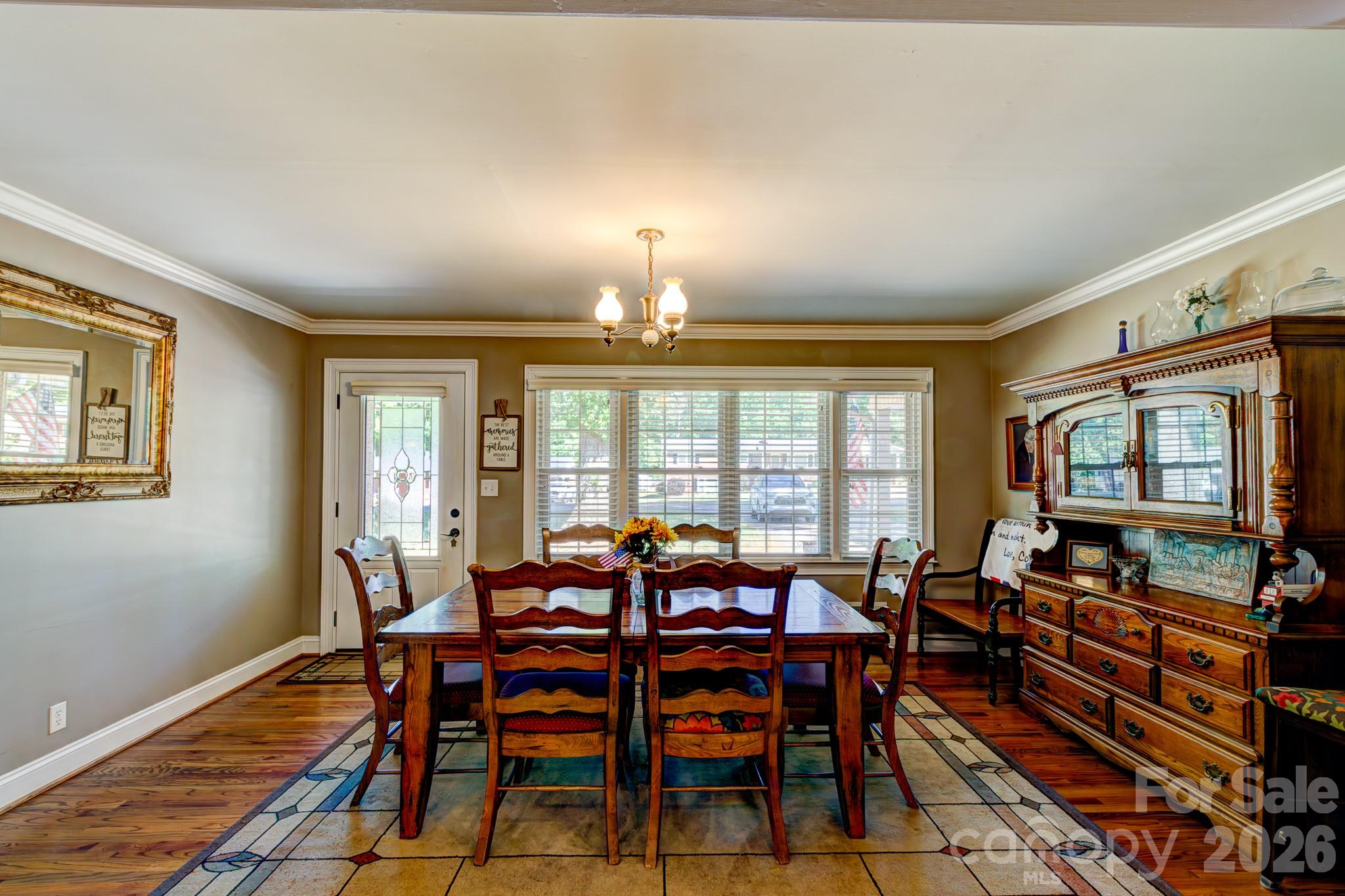 113 Delview Drive Cherryville, NC 28021 - Photo 5 of 26 a view of a dining room with furniture a chandelier and wooden floor