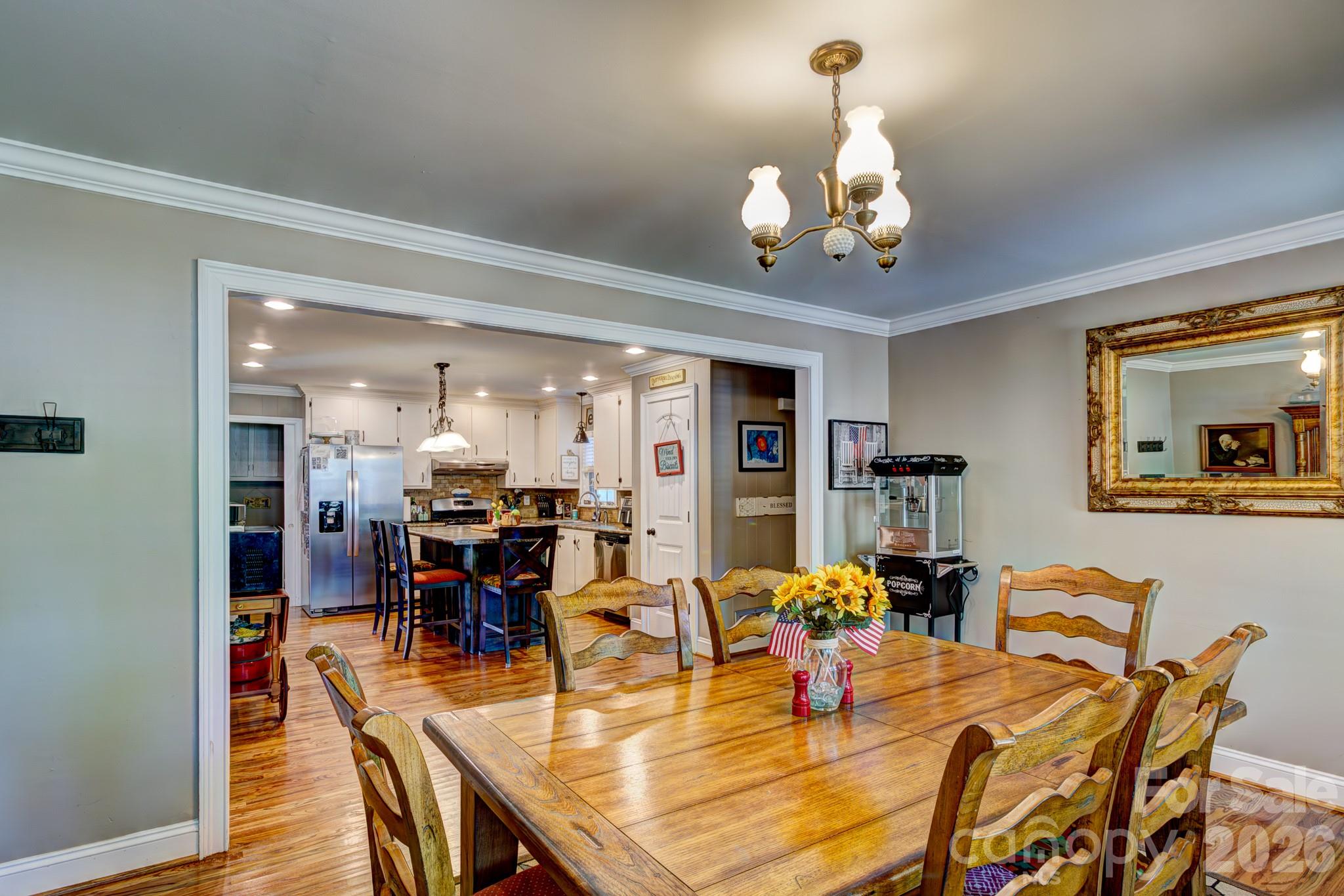 113 Delview Drive Cherryville, NC 28021 - Photo 7 of 26 a view of a dining room with furniture a chandelier and wooden floor