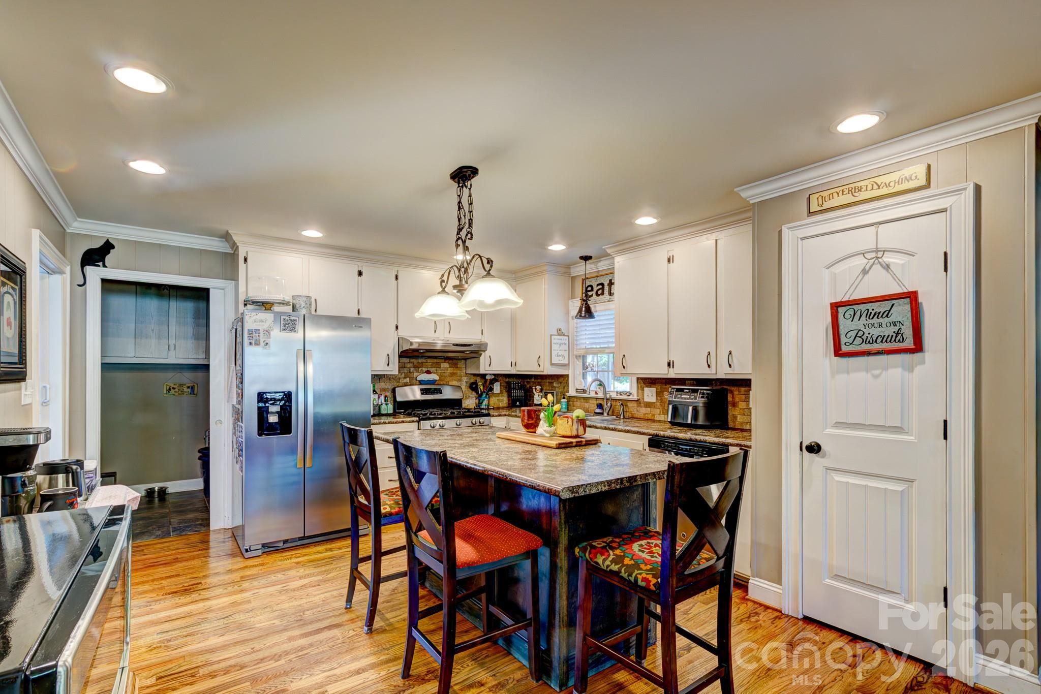 113 Delview Drive Cherryville, NC 28021 - Photo 8 of 26 a kitchen with stainless steel appliances a table and chairs in it