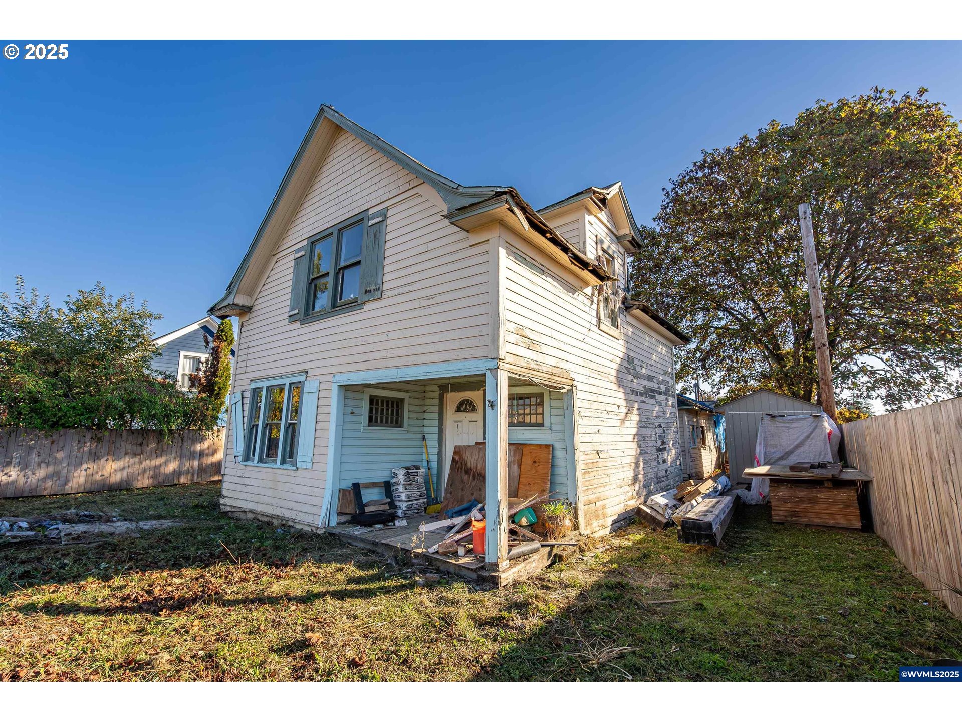 a view of house with backyard space and garden