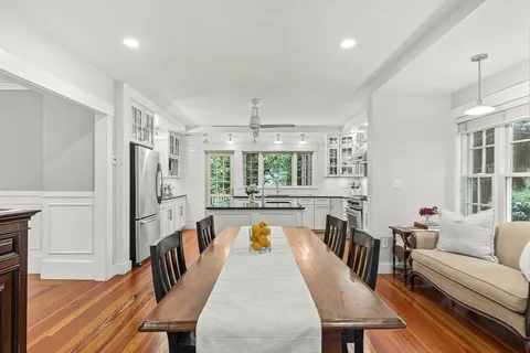 a view of a dining room with furniture window and wooden floor