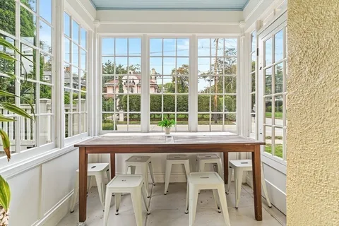 a view of a chair and table in a room with a window