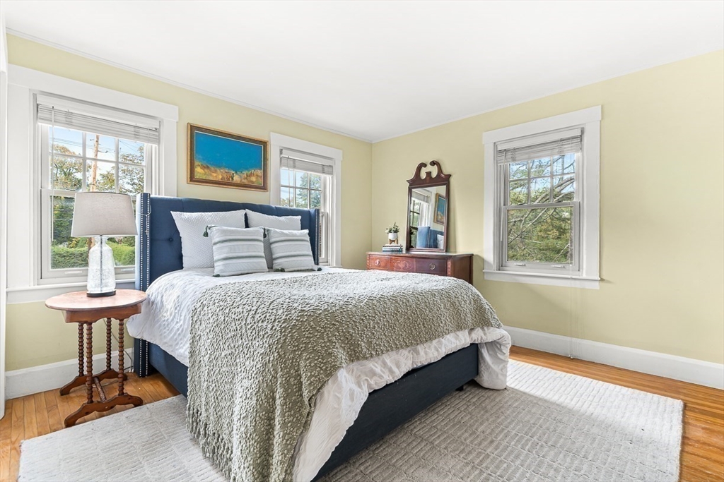 104 Church Street Winchester, MA 01890 - Photo 26 of 42 a large bed sitting in a bedroom next to a window