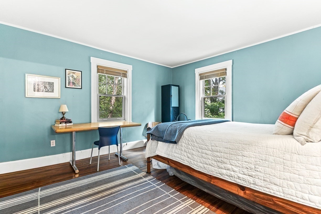 104 Church Street Winchester, MA 01890 - Photo 28 of 42 a bedroom with a bed a table and a window