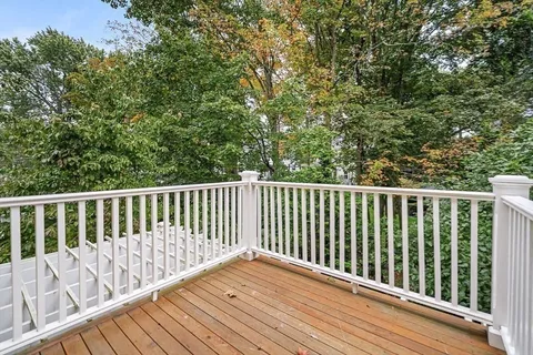a balcony with wooden floor and fence