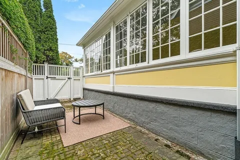 a balcony with chairs and a table