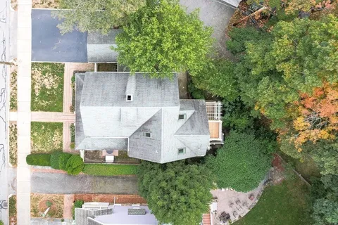 an aerial view of a house with a yard