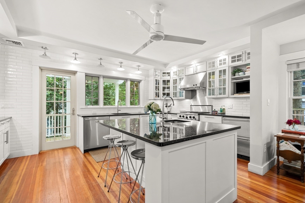 104 Church Street Winchester, MA 01890 - Photo 9 of 42 a kitchen with stainless steel appliances granite countertop a stove and a wooden floors
