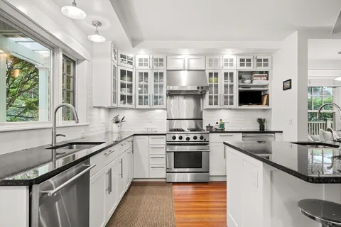 a kitchen with stainless steel appliances granite countertop a sink stove and refrigerator