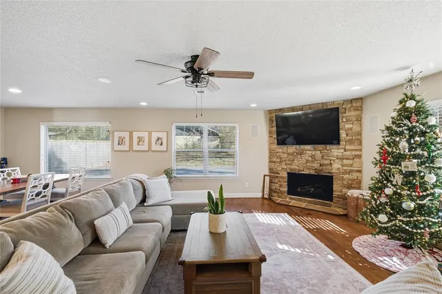 a living room with furniture a flat screen tv and a fireplace