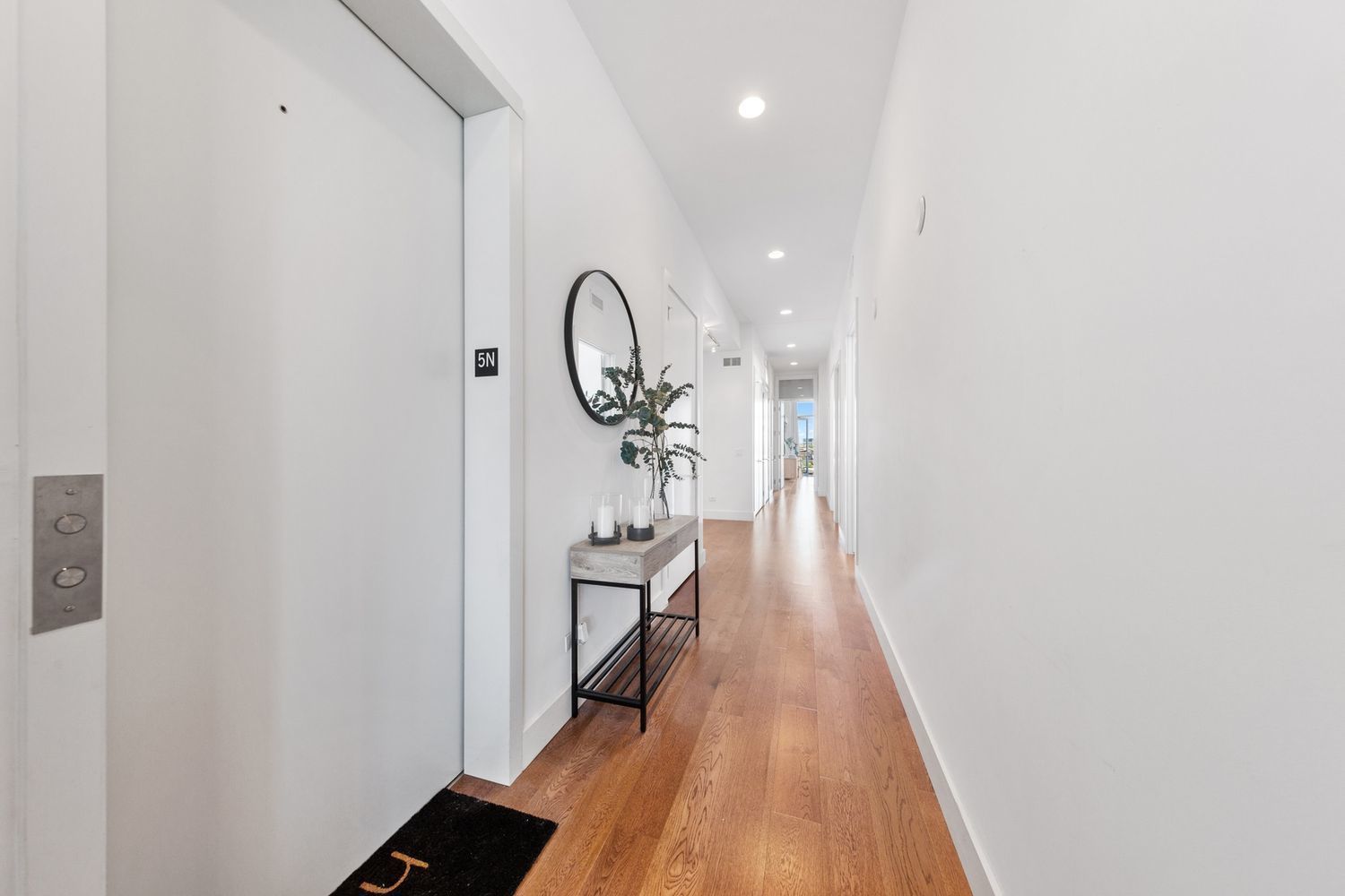 122 South Aberdeen Street, Unit 5N Chicago, IL 60607 - Photo 9 of 23 a view of a hallway with wooden floor and staircase