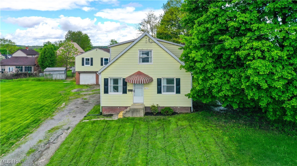 652 South State Line Road Masury, OH 44438 - Photo 20 of 23 View of front facade with driveway, a front yard, and a garage