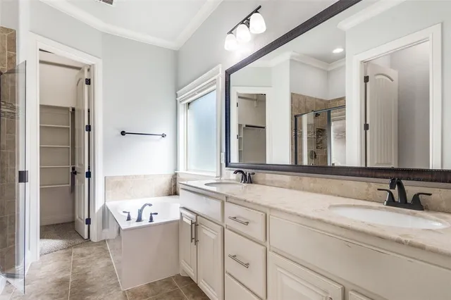 a bathroom with a granite countertop sink mirror and bathtub