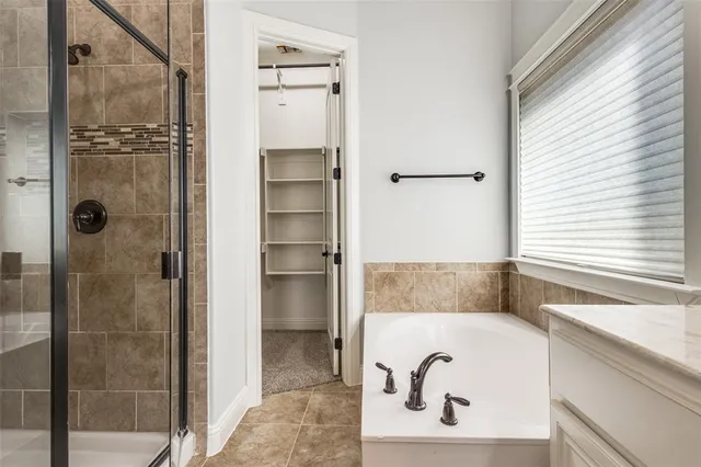 a bathroom with a tub and shower