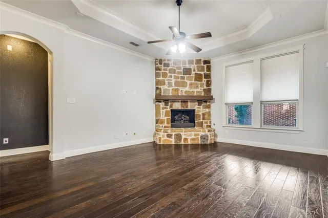 a view of empty room with wooden floor and fireplace