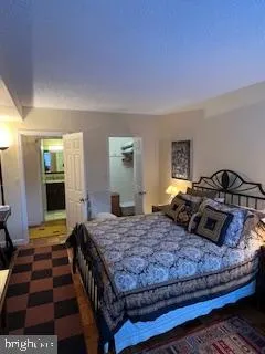 a bedroom with a bed and a dresser with mirror
