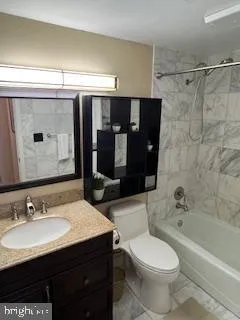 a bathroom with a sink vanity granite toilet tub and shower