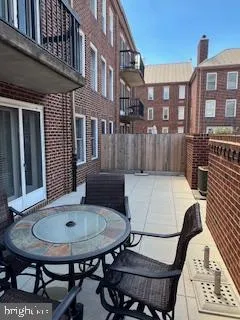 a view of a patio with table and chairs