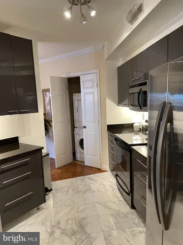 a kitchen with stainless steel appliances granite countertop a stove and a refrigerator