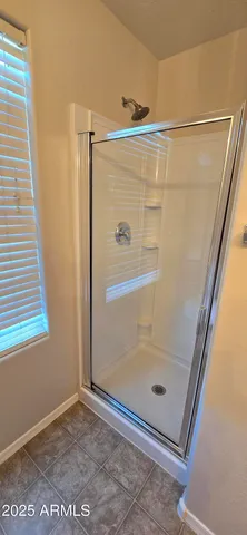 a bathroom with a granite countertop sink mirror and a bathtub