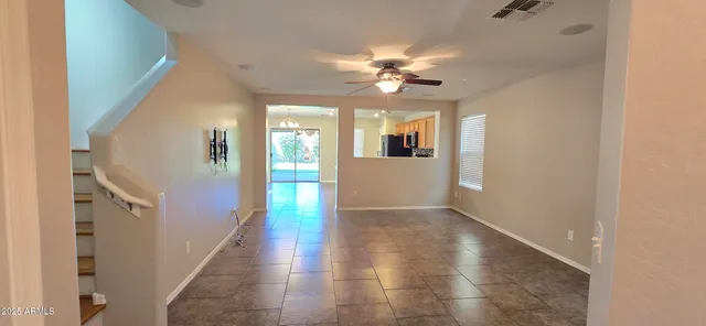 a view of a livingroom with a ceiling fan and window