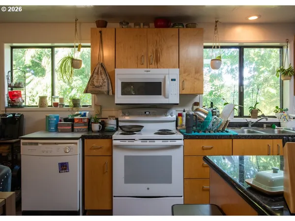 a kitchen with a stove a sink and a microwave
