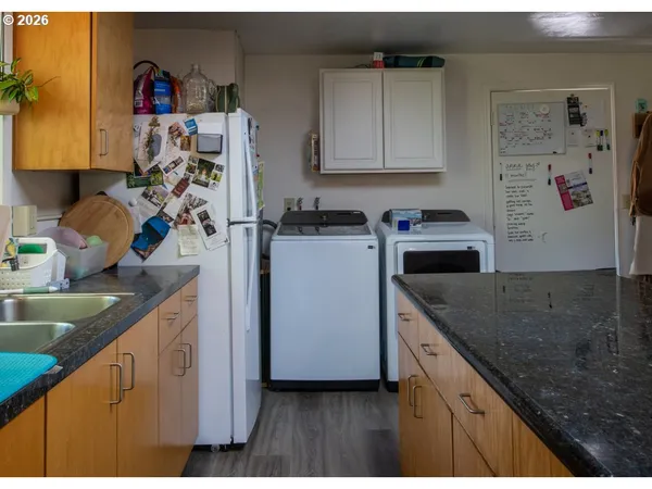 a kitchen with stainless steel appliances granite countertop a refrigerator and a sink
