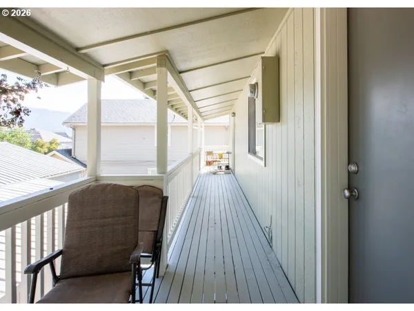 a view of a balcony with wooden floor