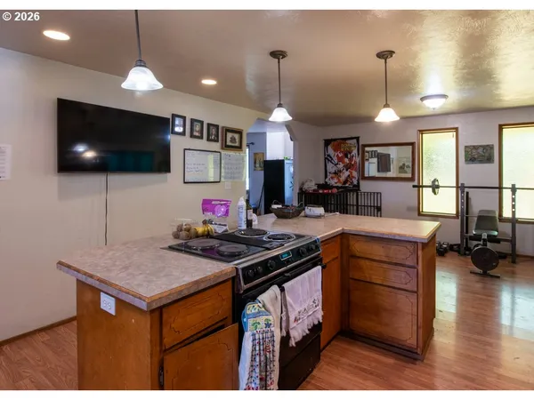 a kitchen that has a sink a counter top space appliances and cabinets