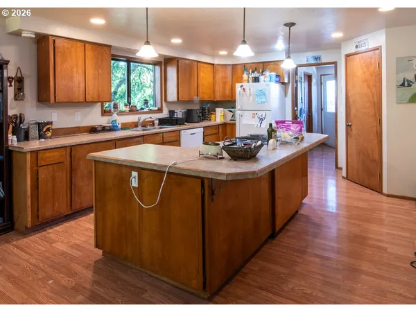 a kitchen with stainless steel appliances granite countertop a sink a refrigerator and a stove
