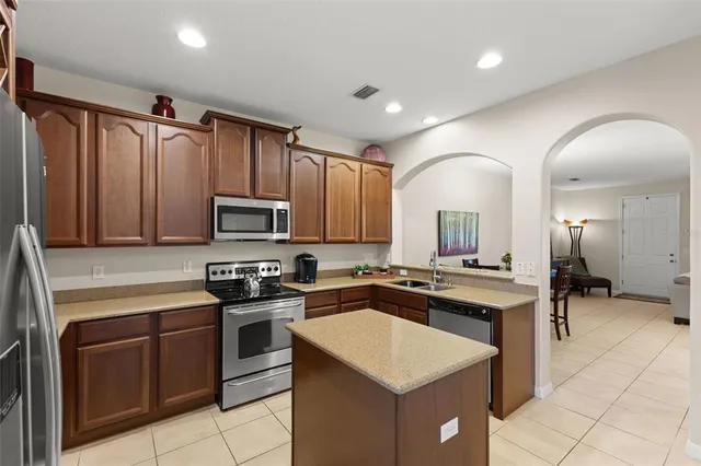a kitchen with a sink stove and microwave