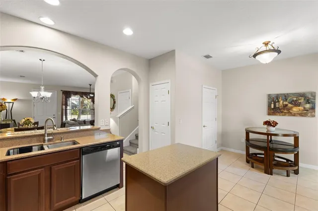a kitchen with a sink cabinets and wooden floor
