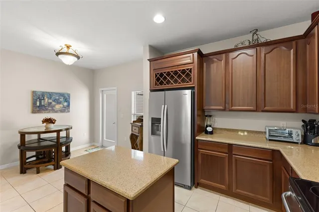 a kitchen with stainless steel appliances a refrigerator and a stove top oven