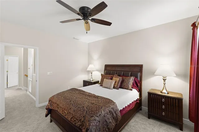 a bedroom with a bed and a lamp on a dresser