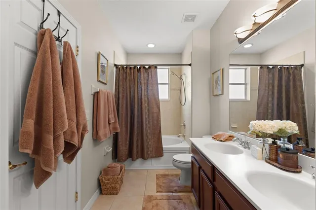 a bathroom with a sink mirror and shower