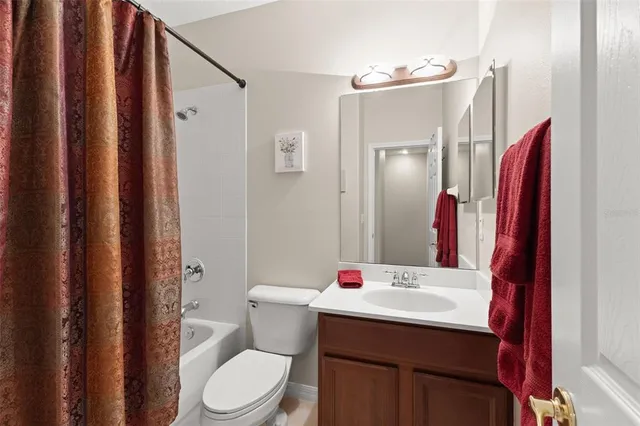 a bathroom with a sink vanity mirror and toilet