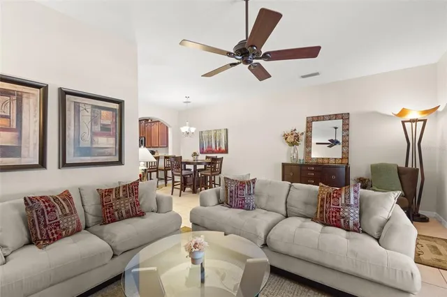 a living room with furniture and a ceiling fan