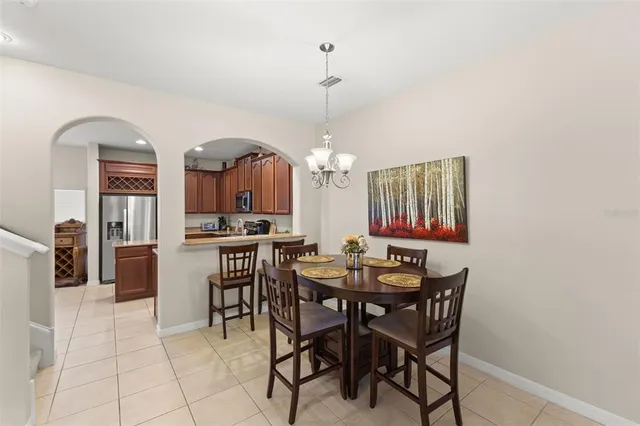 a view of a dining room with furniture and a chandelier
