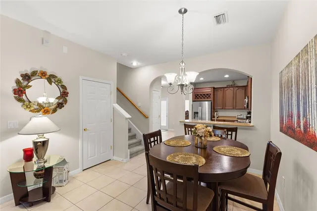 a view of a dining room with furniture and chandelier