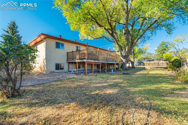 8340 Piute Road Colorado Springs, CO 80926 - Photo 7 of 48 Rear view of property with a deck and stucco siding