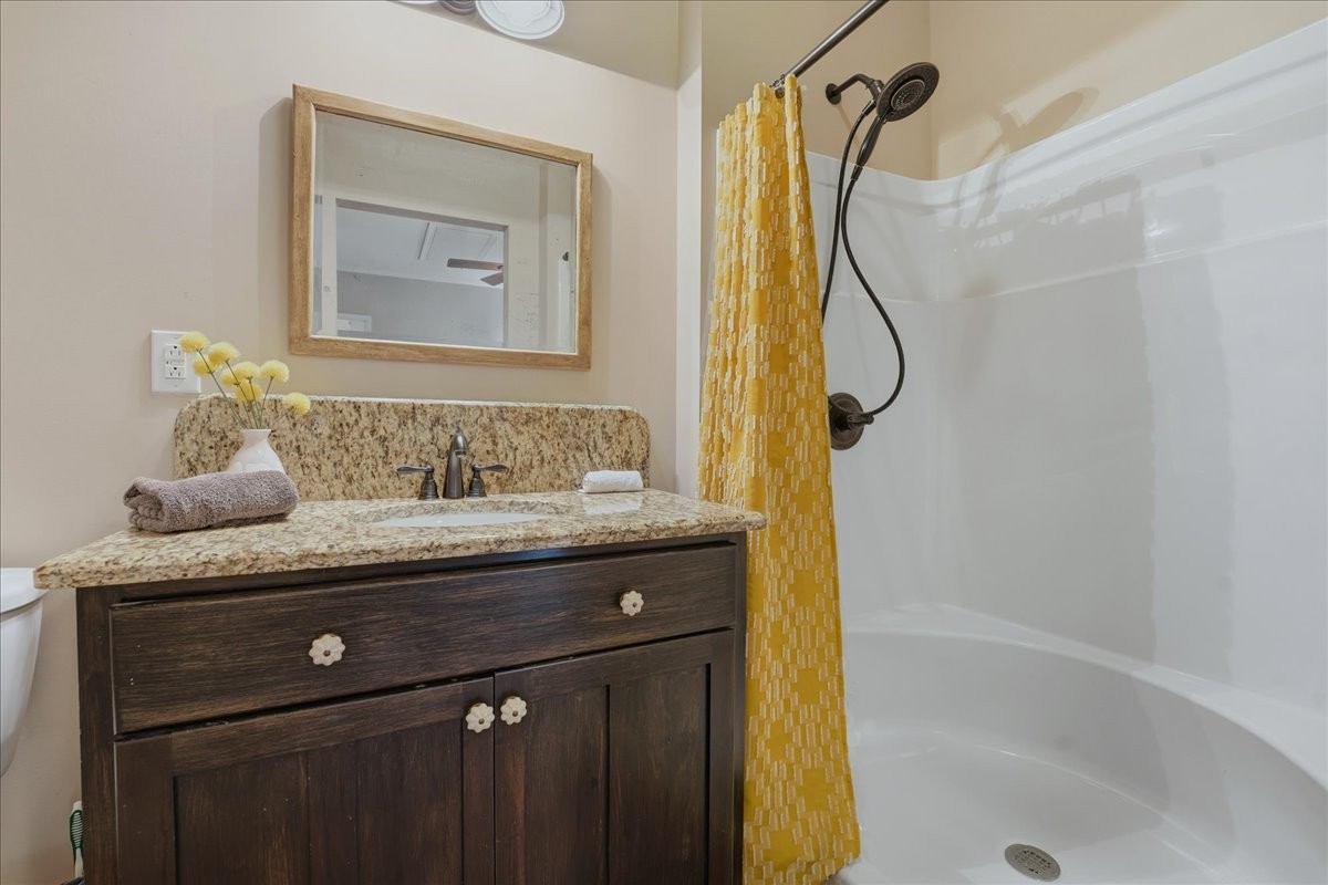 104 Kemper Court Springfield, TN 37172 - Photo 27 of 40 a bathroom with a granite countertop sink a mirror a shower and a bathtub
