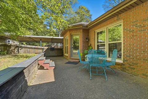 a view of a house with backyard sitting area and garden