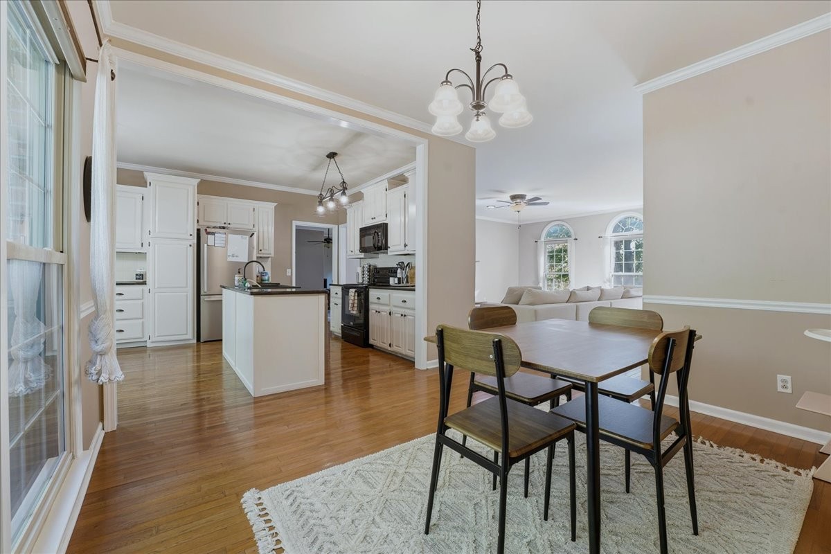 104 Kemper Court Springfield, TN 37172 - Photo 8 of 40 a view of a dining room and livingroom with furniture wooden floor a chandelier