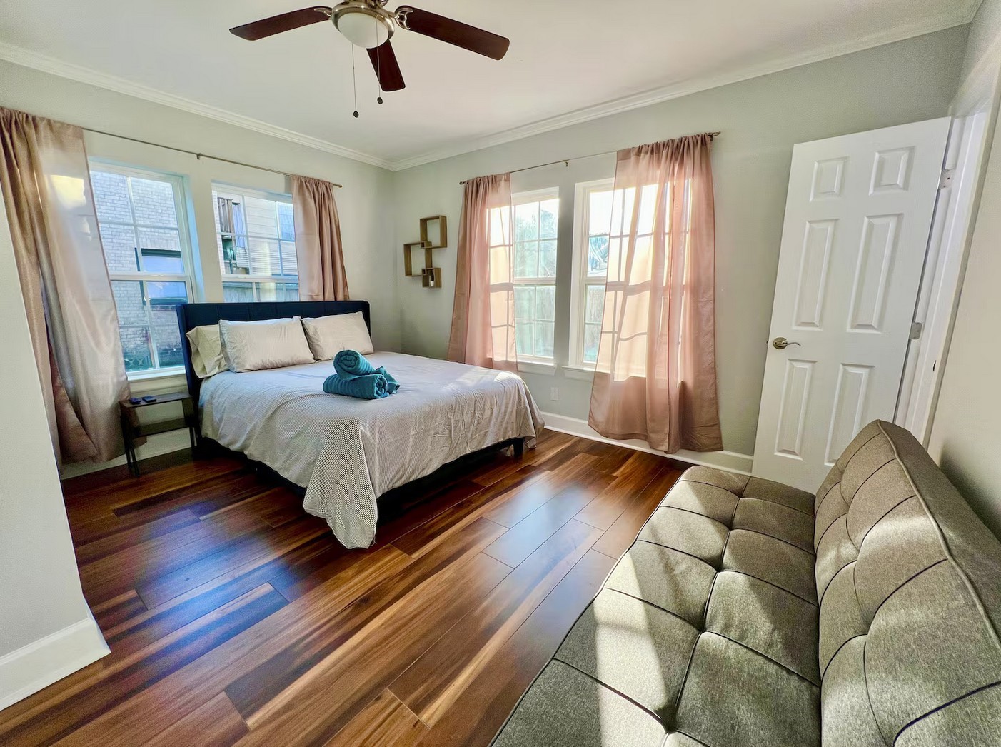 a living room with a bed furniture and a large window